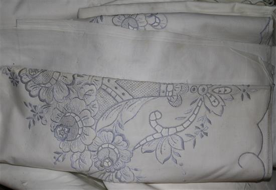A large collection of embroidered sheets and pillow cases